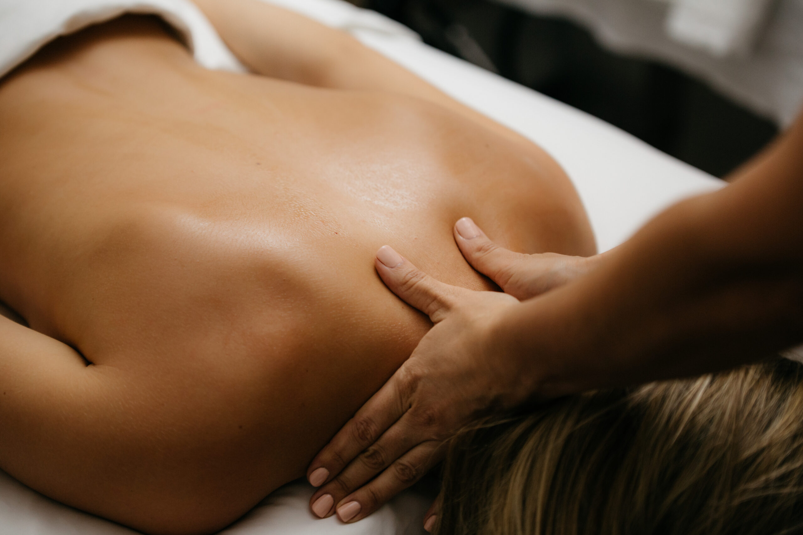 Woman laying face down receiving a massage.