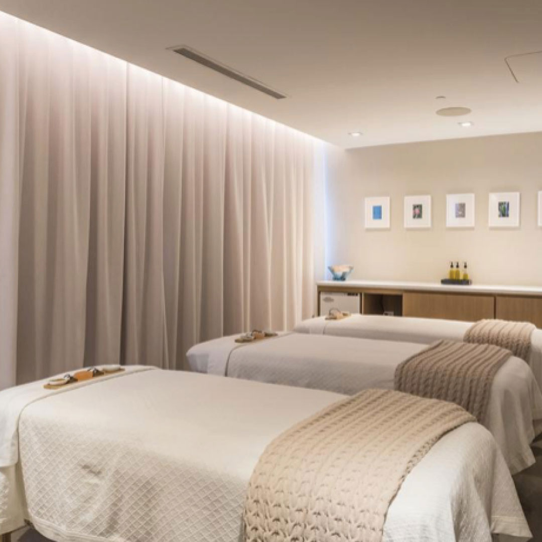 Three massage beds in a luxurious spa treatment room.