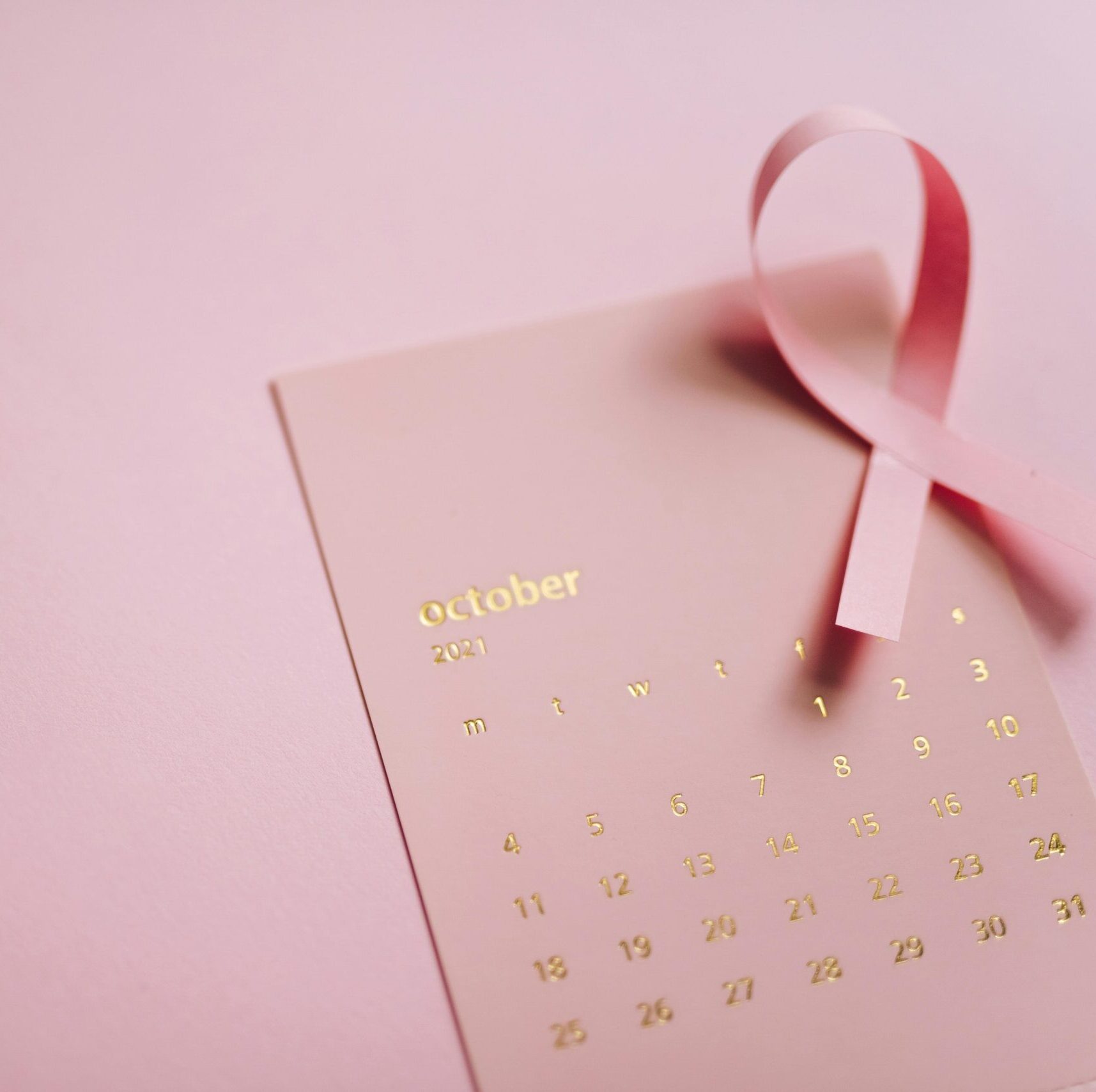 pink ribbon with October calendar on the background