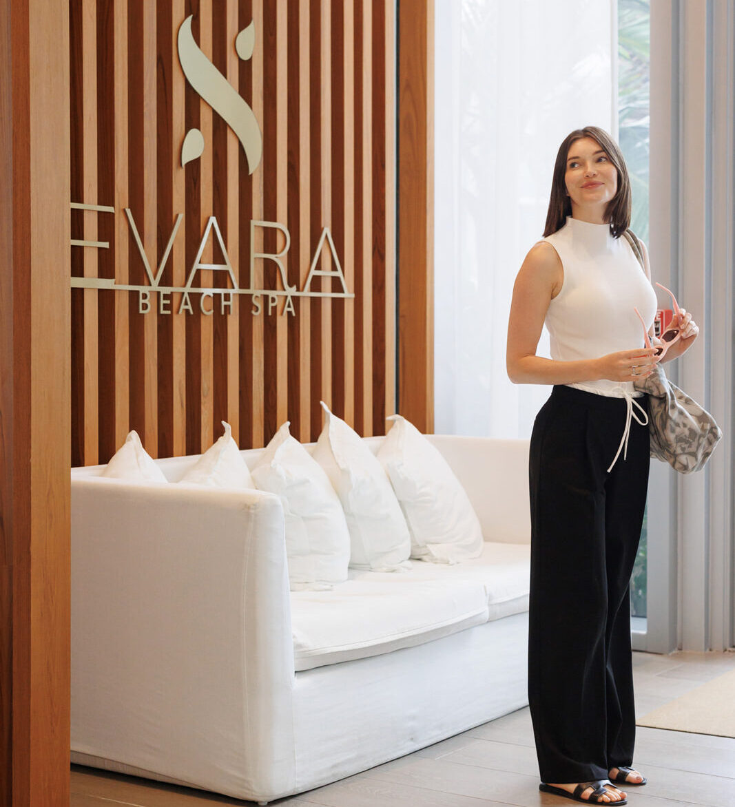woman standing at entrance of EVARA Beach Spa