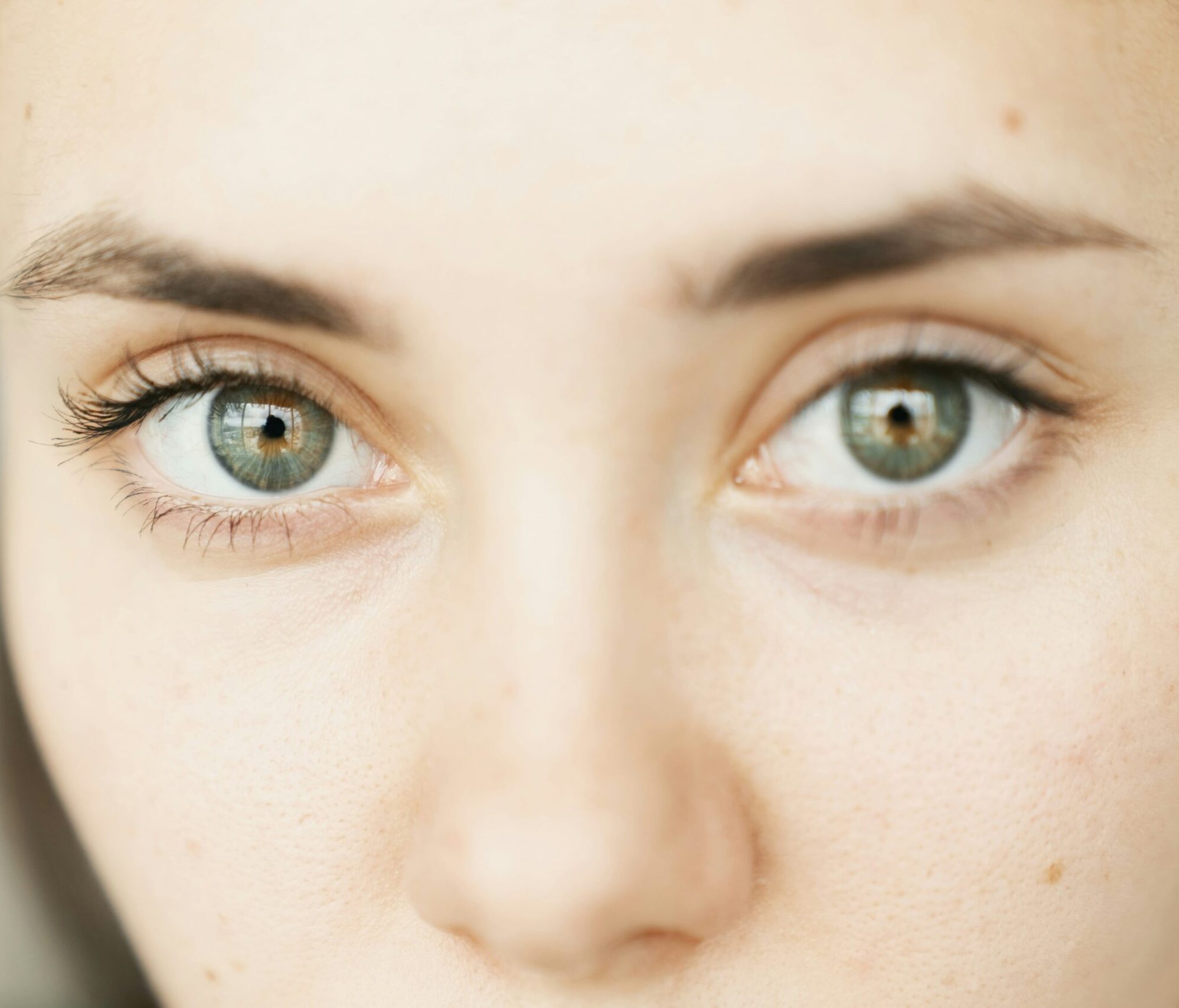 womans two green eyes looking at camera